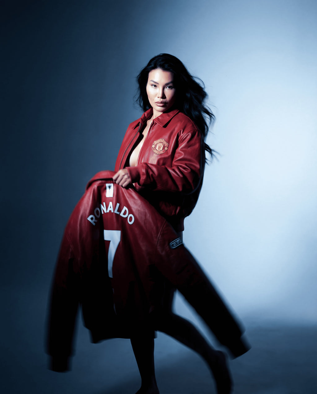 Person wearing a red jacket with 'Ronaldo' and number '7' on a dark background